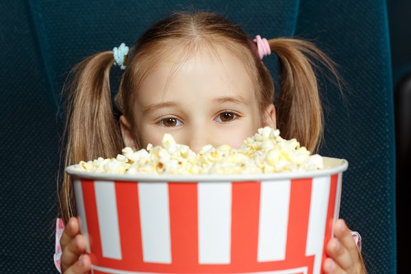Adorable little girl with popcorn
